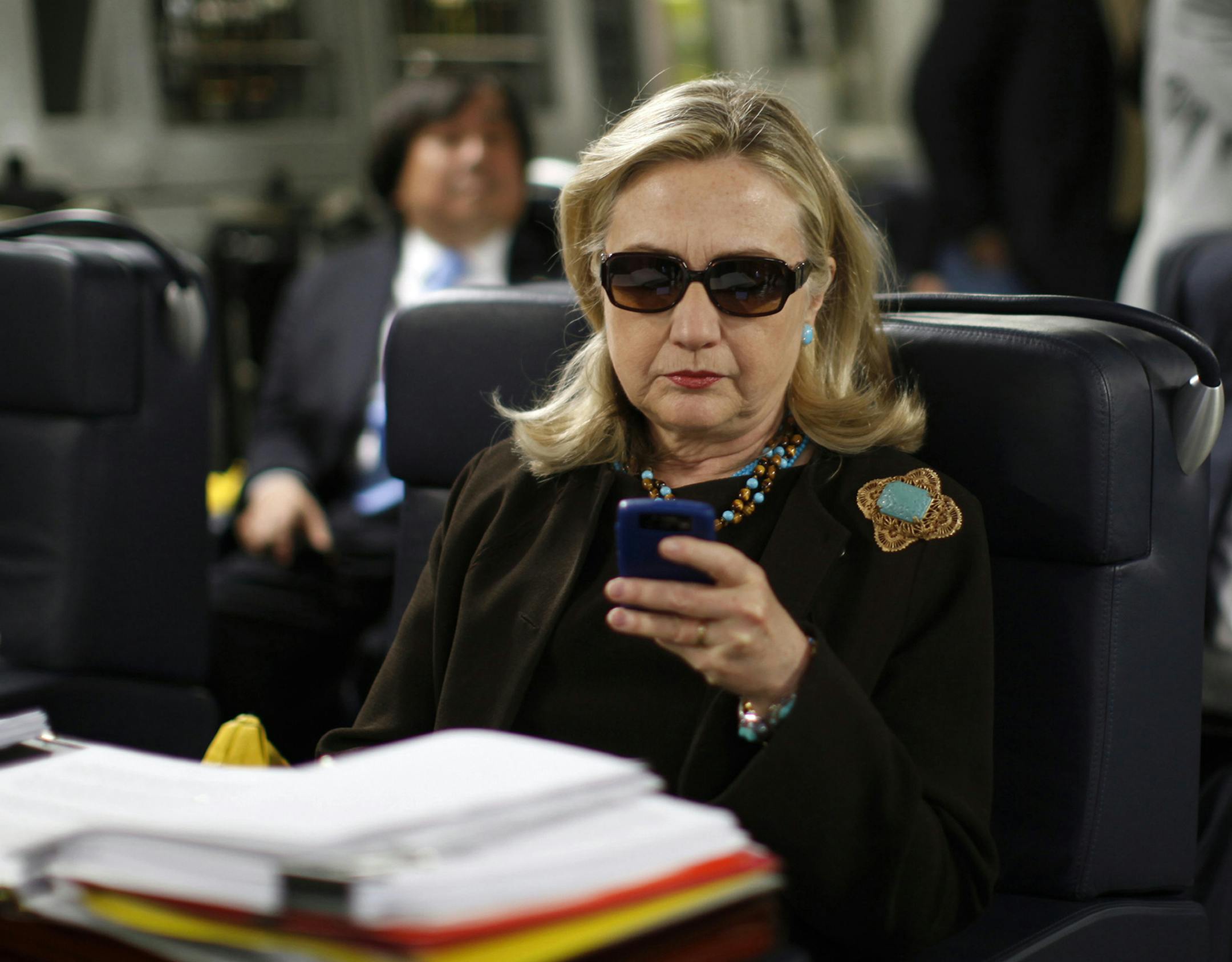 FILE - In this Oct. 18, 2011, file photo, then-Secretary of State Hillary Rodham Clinton checks her Blackberry from a desk inside a C-17 military plane upon her departure from Malta, in the Mediterranean Sea, bound for Tripoli, Libya. The Obama administration is confirming, Friday, Jan. 29, 2016, for the first time that Hillary Clinton's unsecured home server contained some closely guarded secrets, including material requiring one of the highest levels of classification. (Kevin Lamarque/Pool Pho