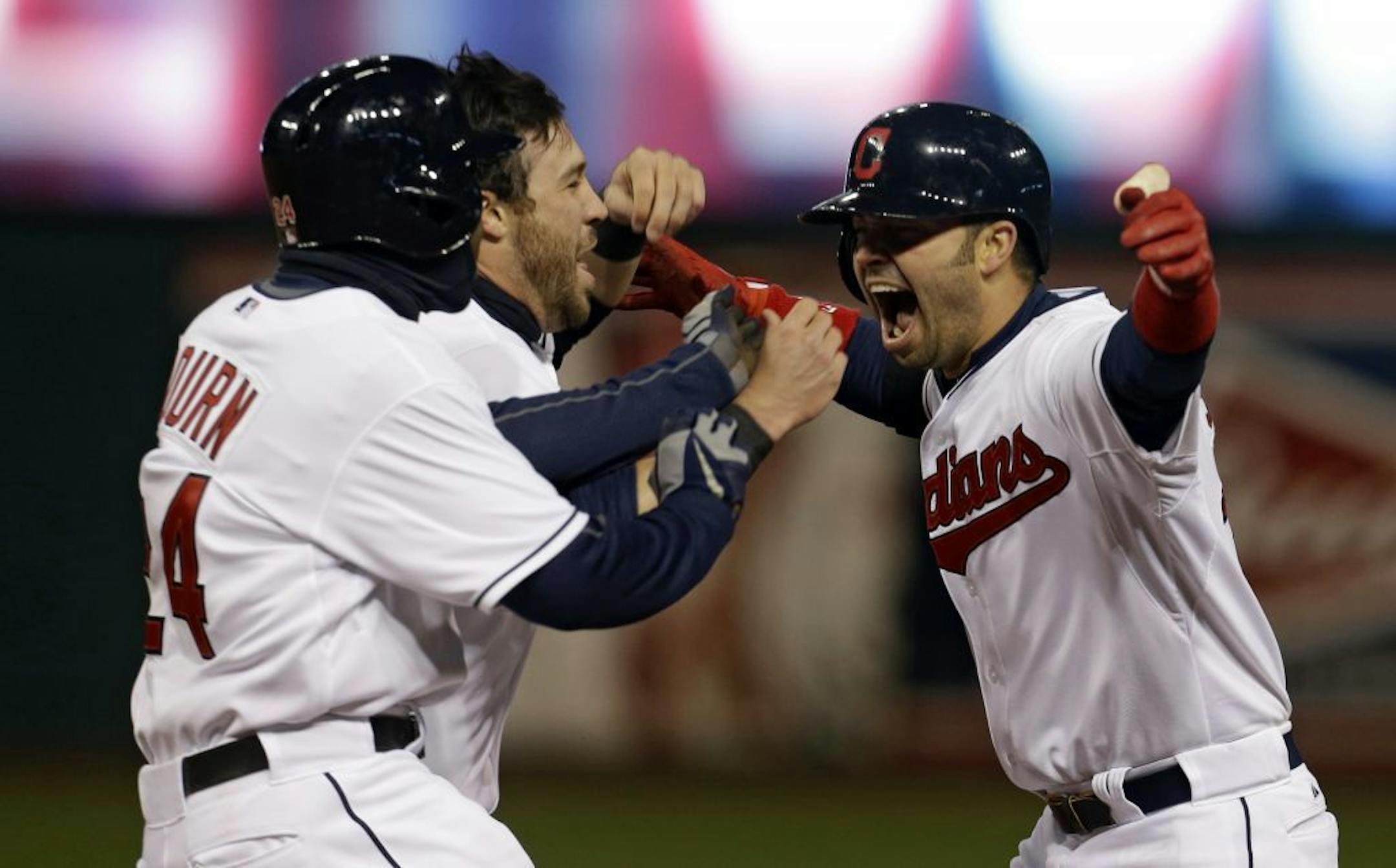 Nick Swisher, right, celebrates with Indians' teammates Michael Bourn, left, and Jason Kipnis after hitting a game-winning RBI-single off Chicago White Sox pitcher Jesse Crain
