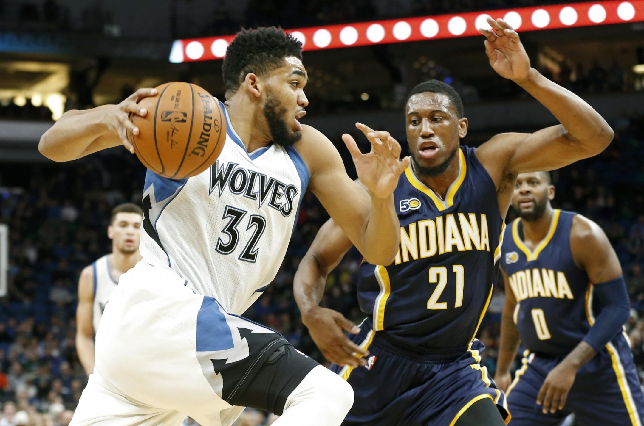 Minnesota Timberwolves' Karl-Anthony Towns, left, drives past Indiana Pacers' Thaddeus Young during the first quarter of an NBA basketball game Thursday, Jan. 26, 2017, in Minneapolis.