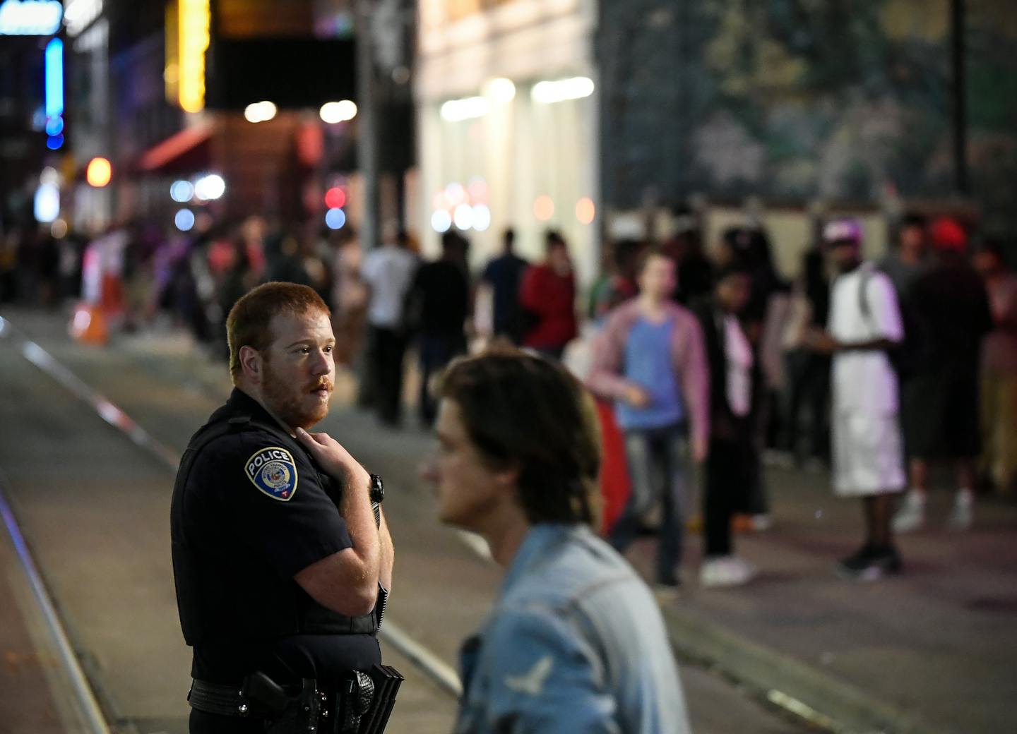 A police officer kept watch in downtown Minneapolis on a recent night after bar close along 5th Street near Hennepin Avenue — hot spots for trouble in terms of both time and place.