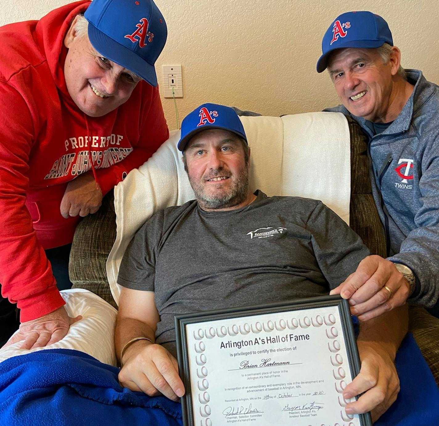 Brian Hartmann is in middle, with brother Dave to left in photo and brother Mike to right. It was when Brian was inducted into the Arlington A's Hall of Fame last Friday. He's the one with fatal illness and only "weeks'' to live.