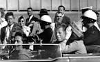 President John F. Kennedy is seen riding in motorcade approximately one minute before he was shot in Dallas on Nov. 22, 1963.