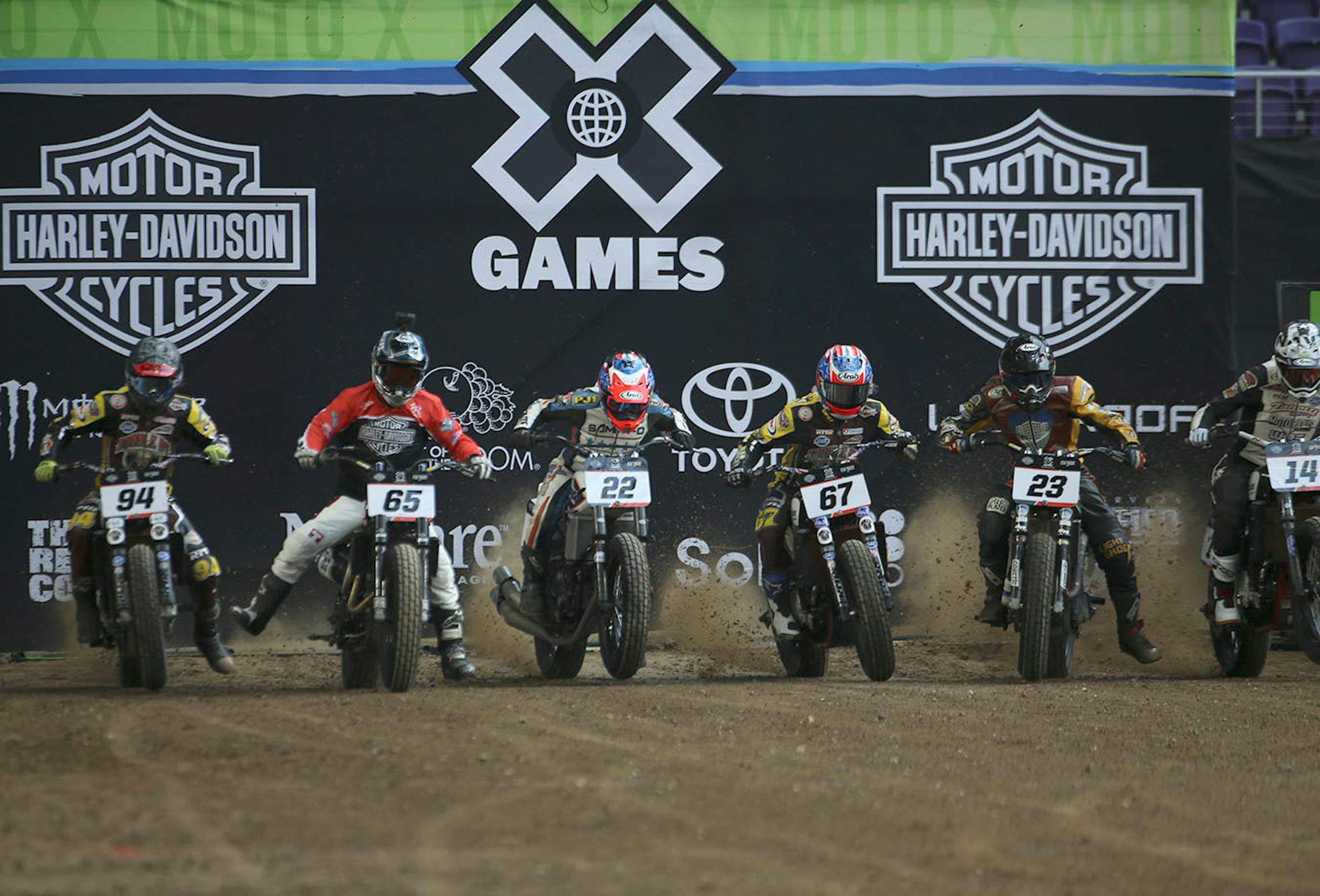 A heat of racers in the quarterfinals of flat racing come out of the starting gate.