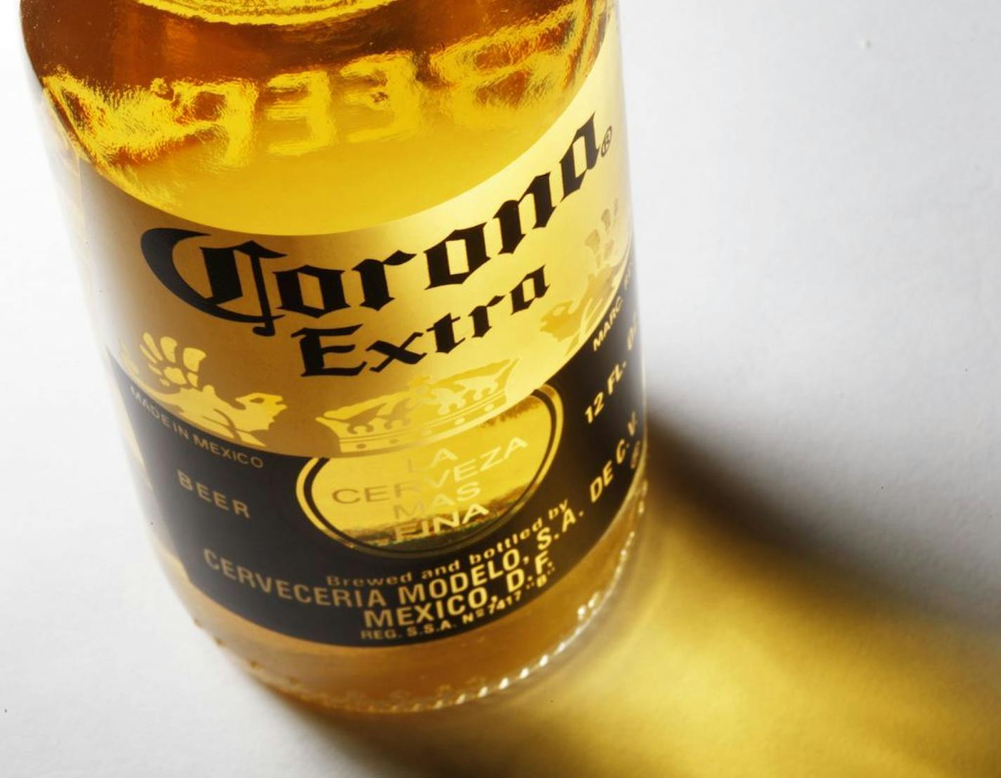 FILE - In this Oct. 5, 2010 file photo, a bottle of Corona Extra beer sits on display, in Philadelphia. Anheuser-Busch InBev SA agreed Friday, June 29, 2012, to buy the half of Corona maker Grupo Modelo it doesn't already own for $20.1 billion in cash, in a deal that will greatly increase the size and dominance of the world's largest brewer.