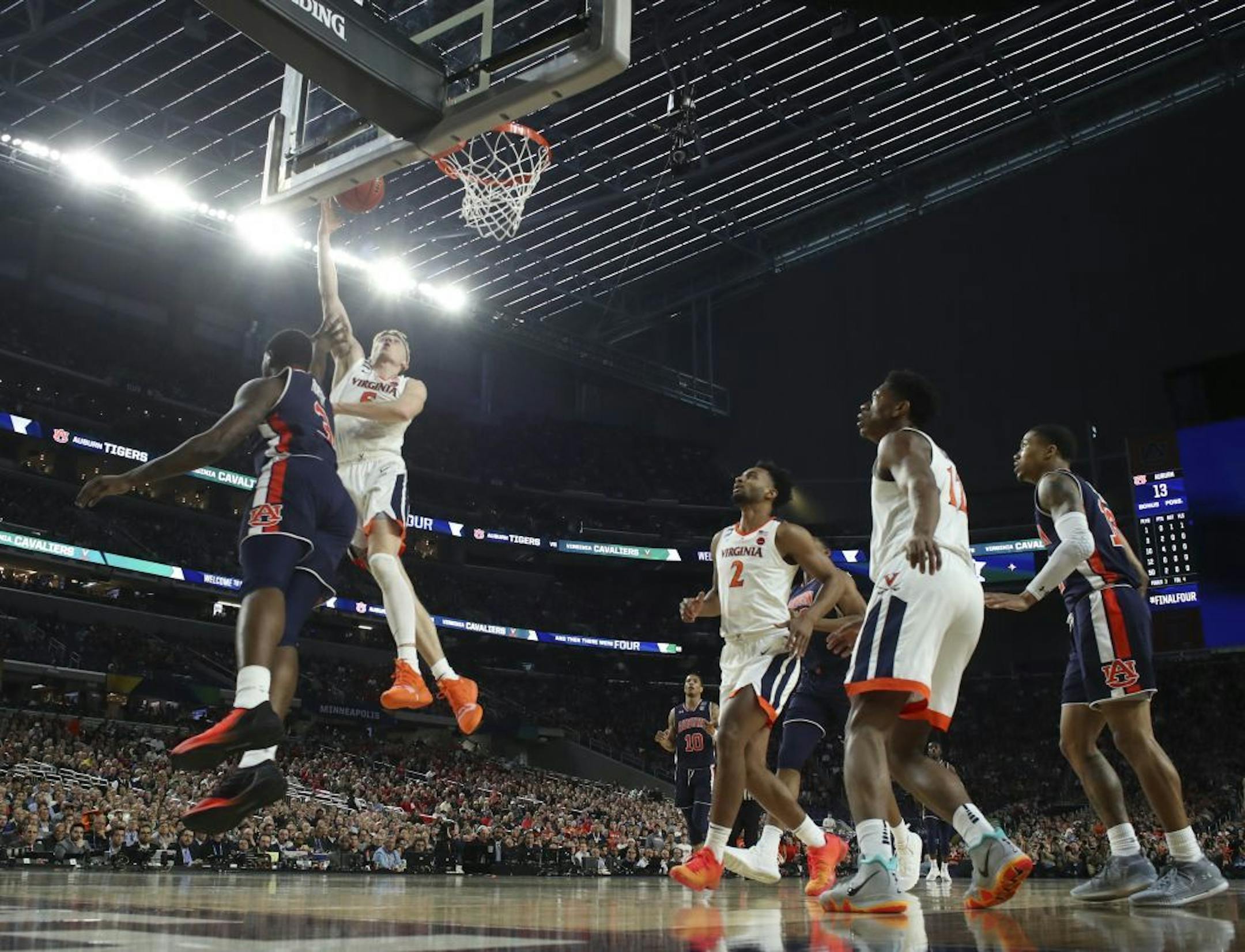Virginia Cavaliers guard Kyle Guy (5) made a shot while defended by Auburn forward Danjel Purifoy (3) during the first half.