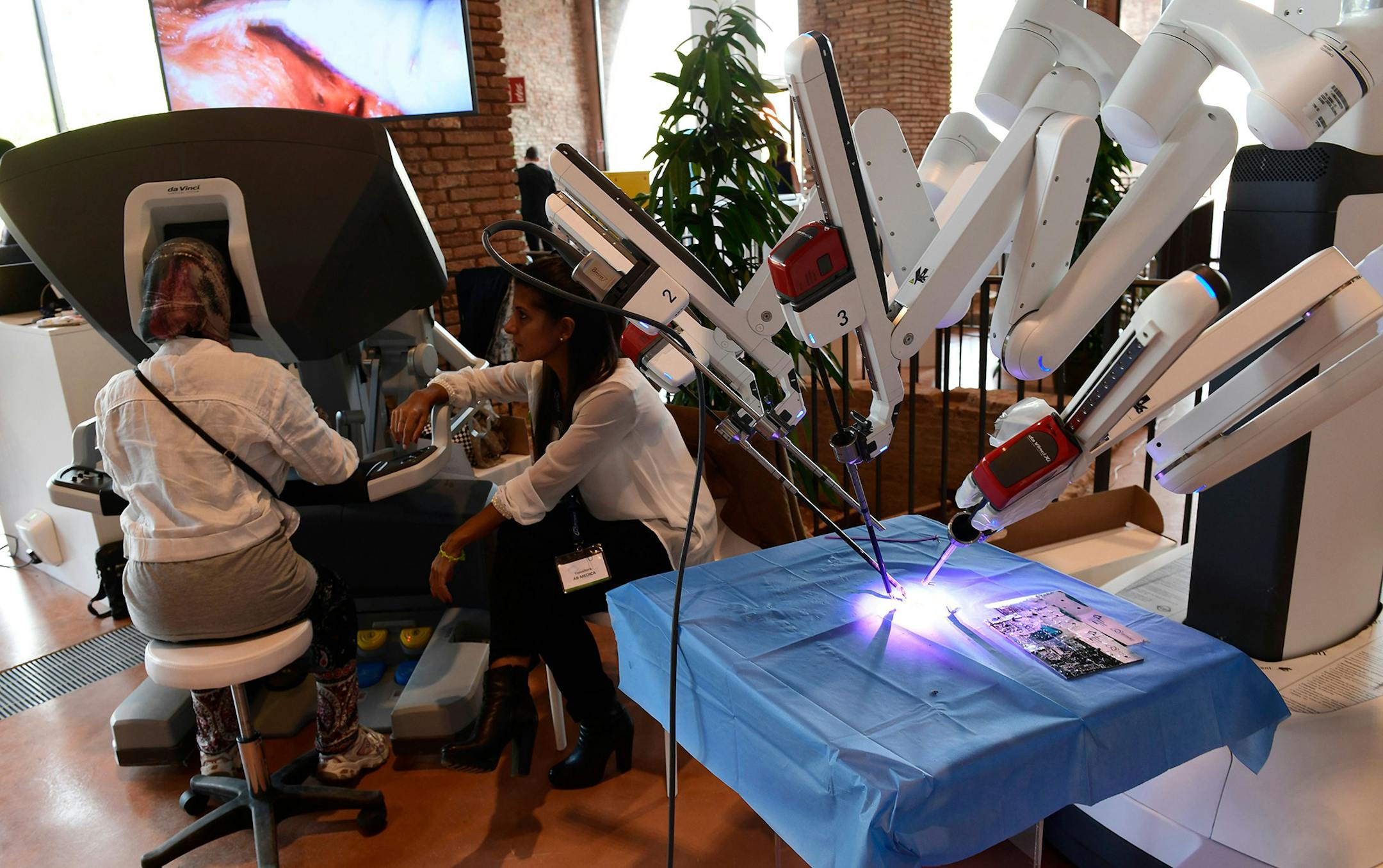 This photograph taken during the International Robotics Festival 2017 in Pisa on September 12, 2017, shows a person manipulating a 'Da Vinci' robot for medical use. (Miguel Meina/AFP/Getty Images/TNS) **FOR USE WITH THIS STORY ONLY** ORG XMIT: 1373321