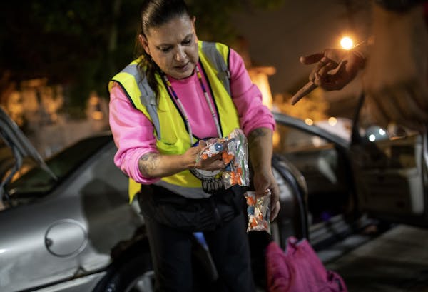 Linda, known as "Moms" on the streets, handed out clean syringes in the Phillips community in September. Linda and her fiance, Mark, go out four to fi