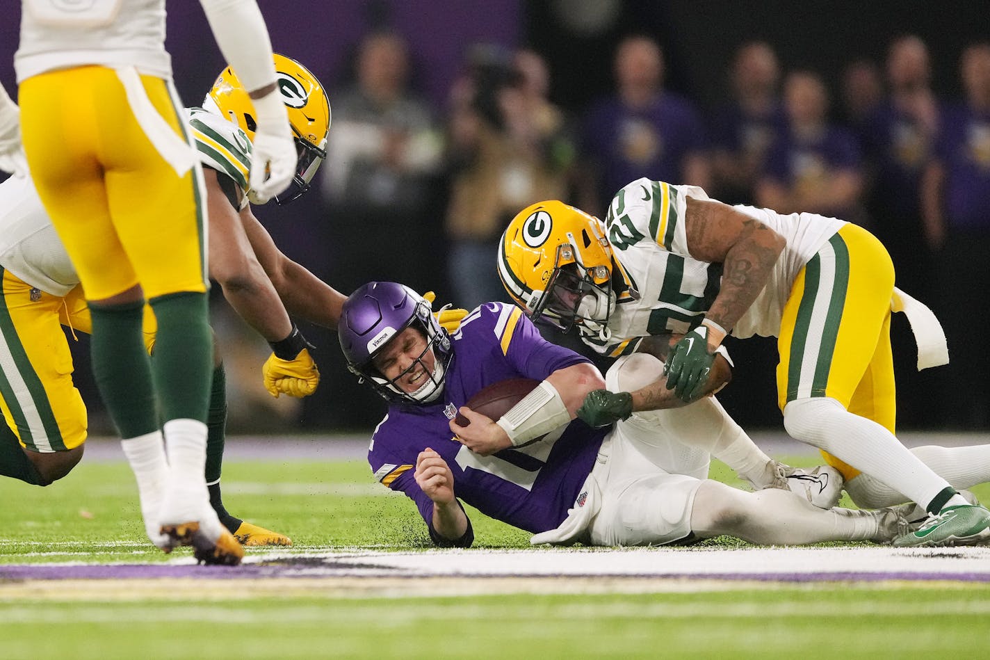 Minnesota Vikings quarterback Nick Mullens (12) gets hit by Green Bay Packers cornerback Keisean Nixon (25) as he slides down after rushing the ball in the fourth quarter of an NFL game between the Minnesota Vikings and the Green Bay Packers Sunday, Dec. 31, 2023 at U.S. Bank Stadium in Minneapolis. ] ANTHONY SOUFFLE • anthony.souffle@startribune.com