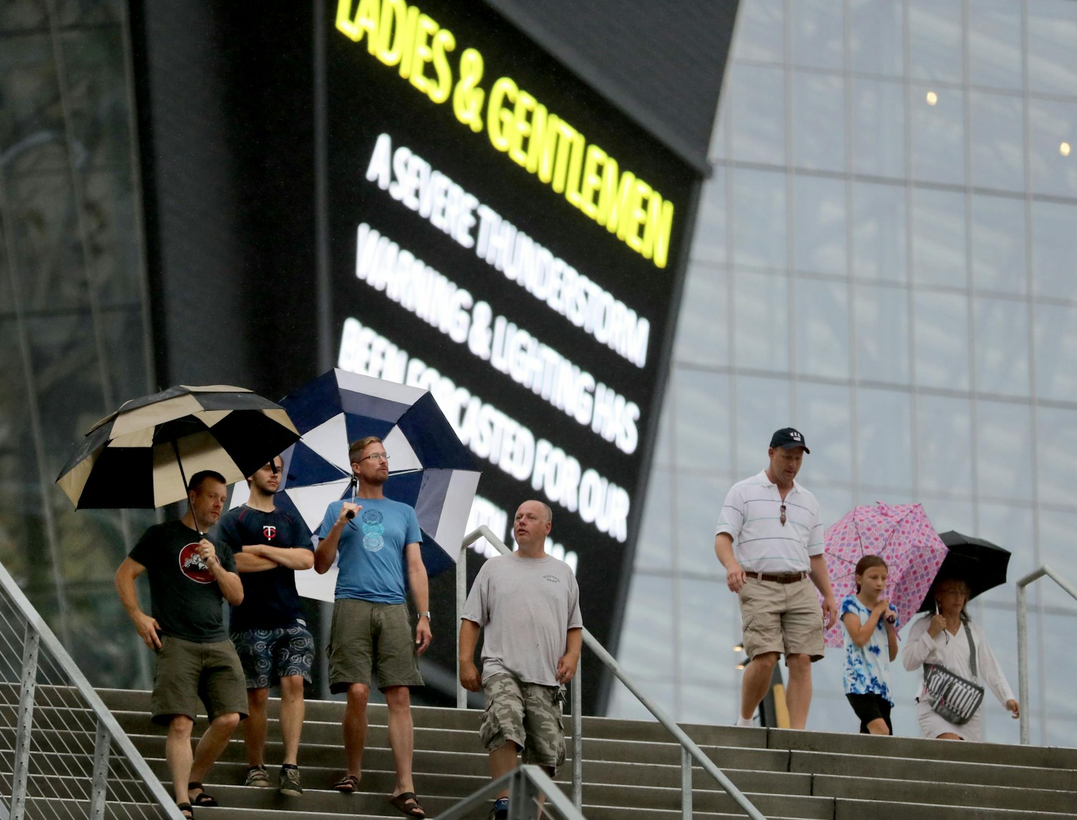 A large video display warned Vikings fans of a storm warning as a large crowd was on hand during a storm at the public opening at the U.S. Bank Stadium Saturday, July 23, 2016, in Minneapolis, MN.