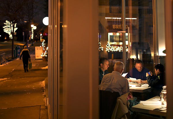 Two tables at the front of Upton 43 have a view of the comings and goings in downtown Linden Hills.