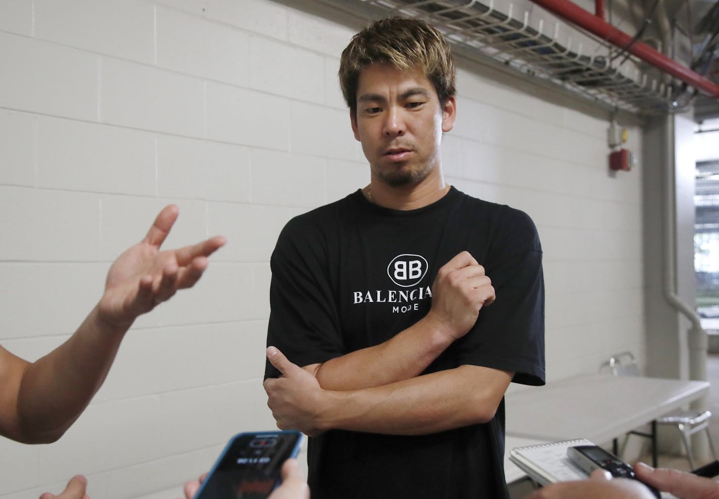 Minnesota Twins pitcher Kenta Maeda, of Japan, speaks to media at Hammond Stadium, Thursday, March 12, 2020, in Fort Myers, Fla., as he reacts to the news that Major League Baseball has suspended the rest of its spring training game schedule because if the coronavirus outbreak. In addition, the league is also delaying the start of its regular season by at least two weeks. (AP Photo/Elise Amendola)