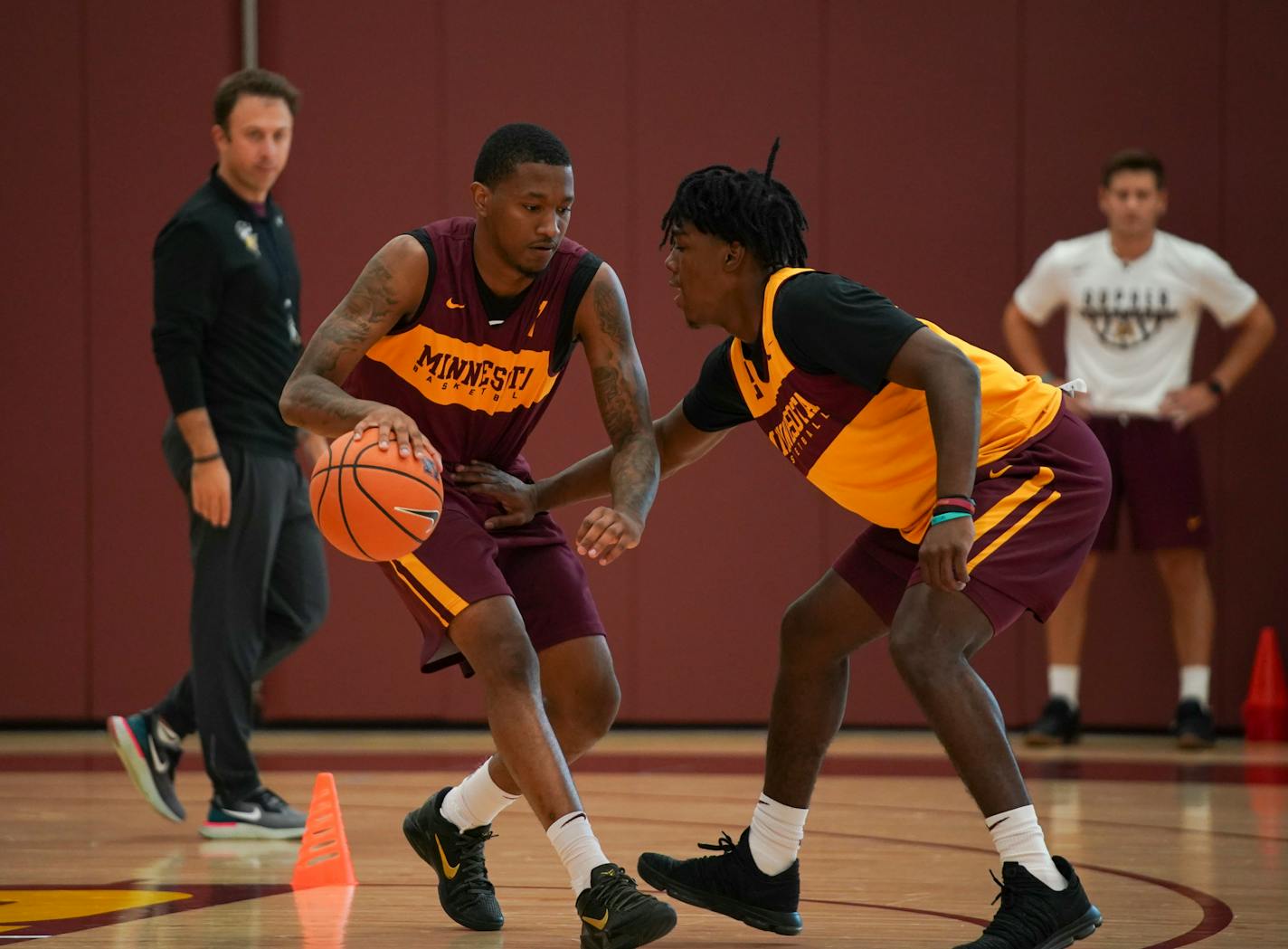 Dupree McBrayer, left, and Marcus Carr took part in a drill during practice Tuesday afternoon while head coach Richard Pitino observed. ] JEFF WHEELER • jeff.wheeler@startribune.com The University of Minnesota men's basketball team practiced Tuesday afternoon, September 25, 2018 at the new basketball facility.