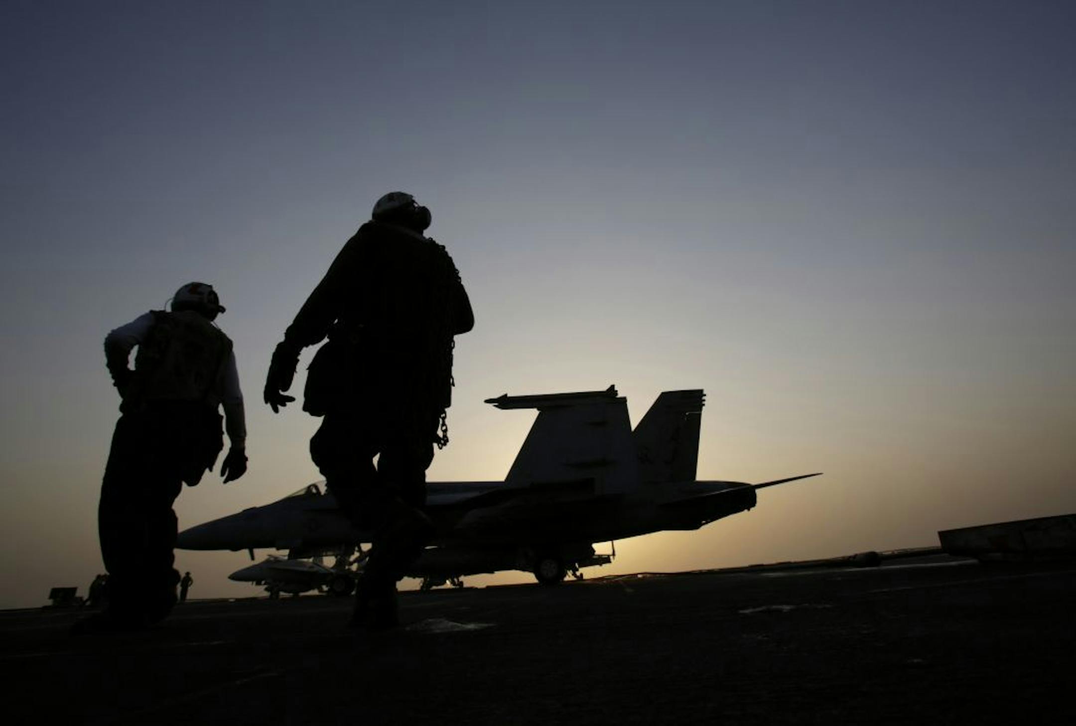 In this Aug. 10, 2014 photo, U.S Navy sailors work on aircrafts for missions targeting the Islamic State group in Iraq from the deck of the U.S. Navy aircraft carrier USS George H.W. Bush in the Persian Gulf. Combined U.S.-Arab airstrikes at the heart of the Islamic State group's military strongholds in Syria achieved their strategic aim of showing the extremists that their savage attacks will not go unanswered, the top American military officer said Tuesday, Sept. 23, 2014.