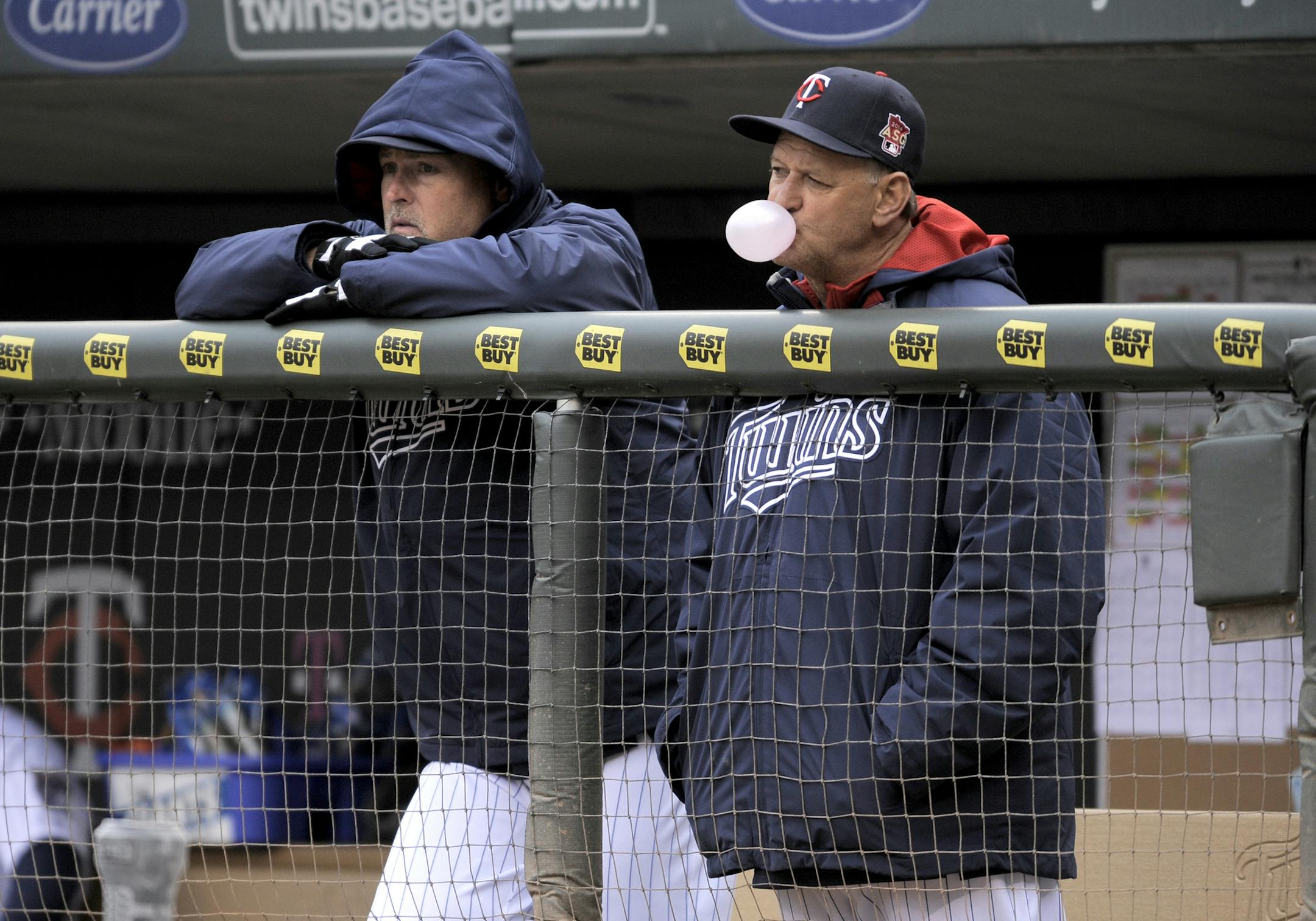 Minnesota Twins coaches Tom Brunansky, left and Terry Steinbach, right, during a baseball game against the Kansas City Royals in Minneapolis, Sunday, April 13, 2014. (AP Photo/Tom Olmscheid) ORG XMIT: NYOTK