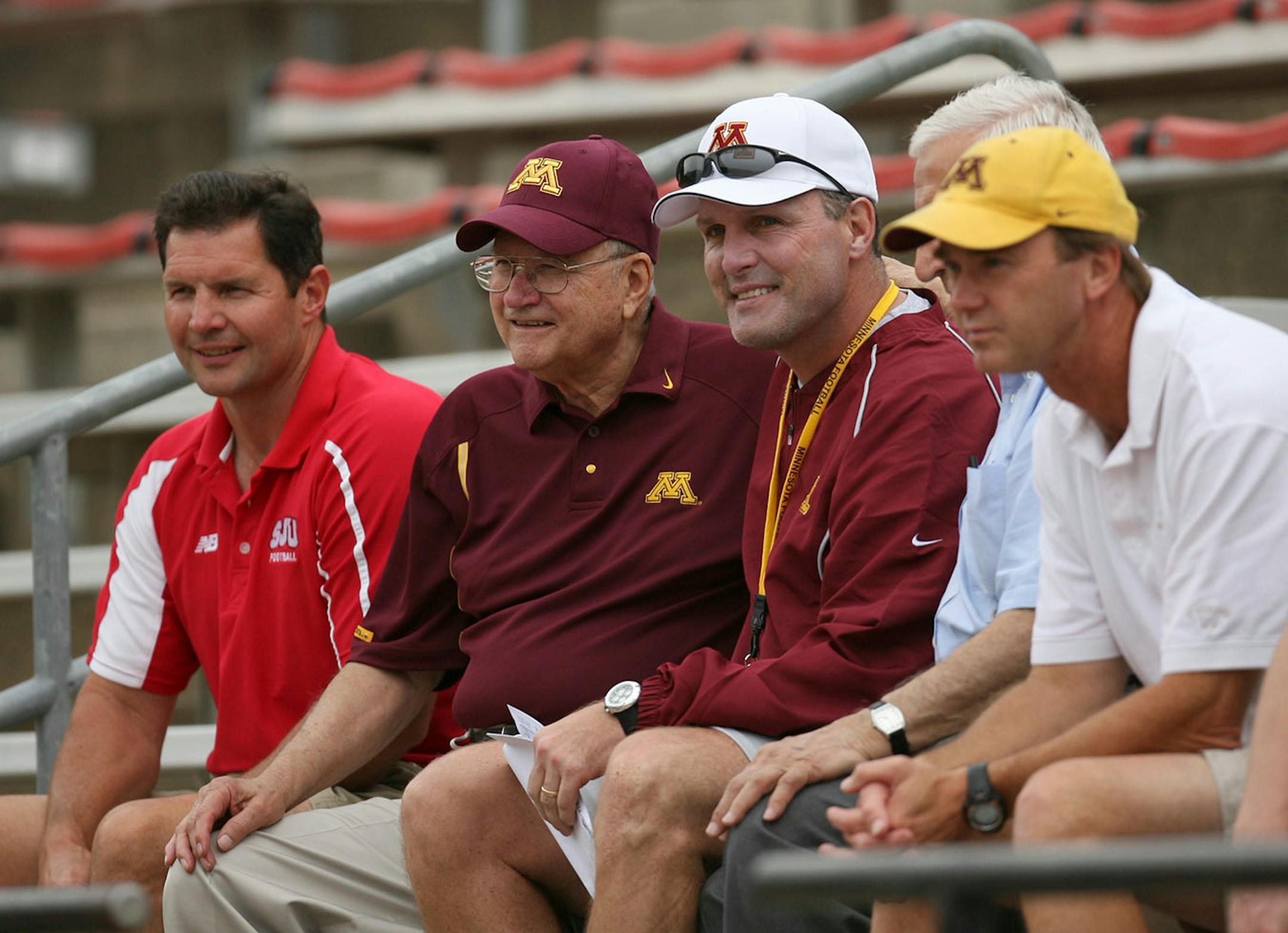Then-Gophers football coach Tim Brewster (white cap) posed for a photo with legendary St. John's football coach John Gagliardi just before the Gophers began a practice in Collegeville, Minn.