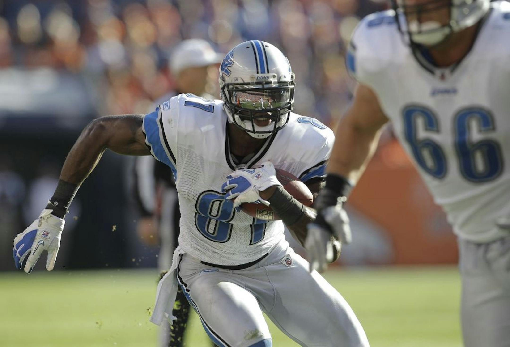 Detroit Lions wide receiver Calvin Johnson (81) runs the ball against the Denver Broncos in the third quarter of an NFL football game, Sunday, Oct. 30, 2011, in Denver.