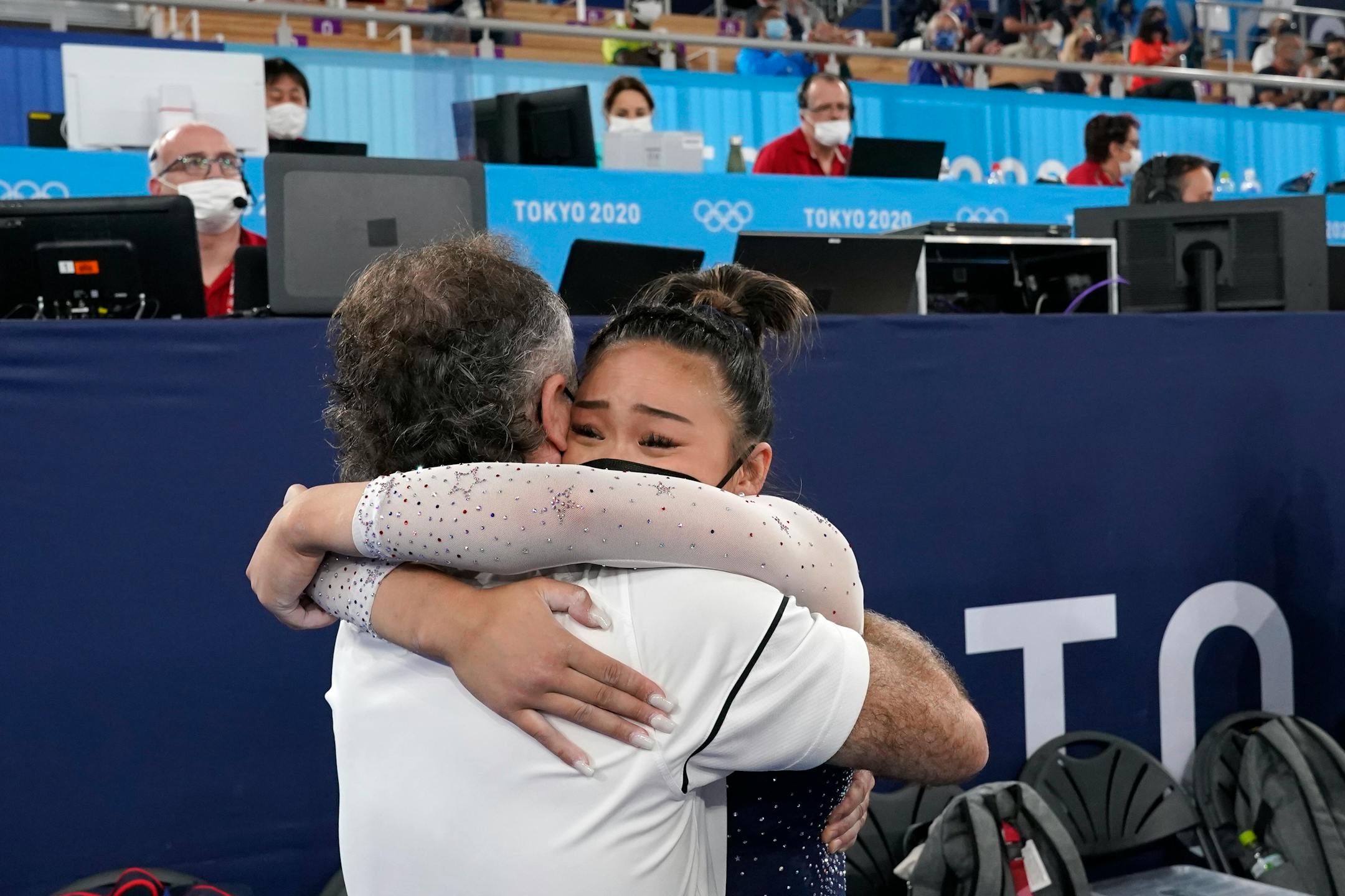 Suni Lee, of the United States, hugs her coach Jeff Graba after she won the gold medal in the artistic gymnastics women's all-around at the 2020 Summer Olympics, Thursday, July 29, 2021, in Tokyo. (AP Photo/Gregory Bull)
