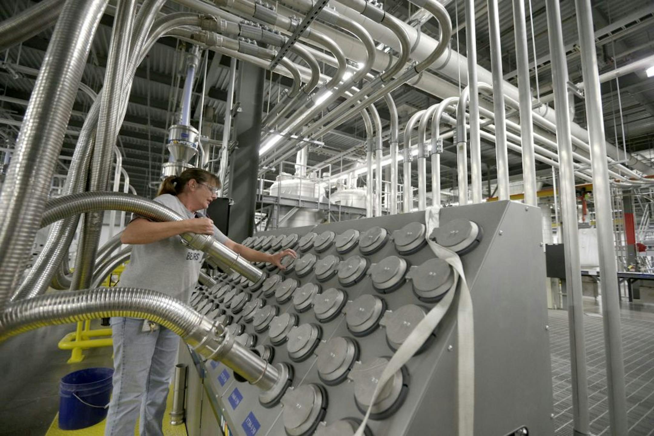 Susan Stacy moves a tube to sort recycled plastic bottle chips being processed at the Repreve Bottle Processing Center, part of the Unifi textile company in Yadkinville, N.C., Friday, Oct. 21, 2016. America has lost more than 7 million factory jobs since manufacturing employment peaked in 1979. Yet American factory production, minus raw materials and some other costs, more than doubled over the same span to $1.91 trillion last year, according to the Commerce Department, which uses 2009 dollars t