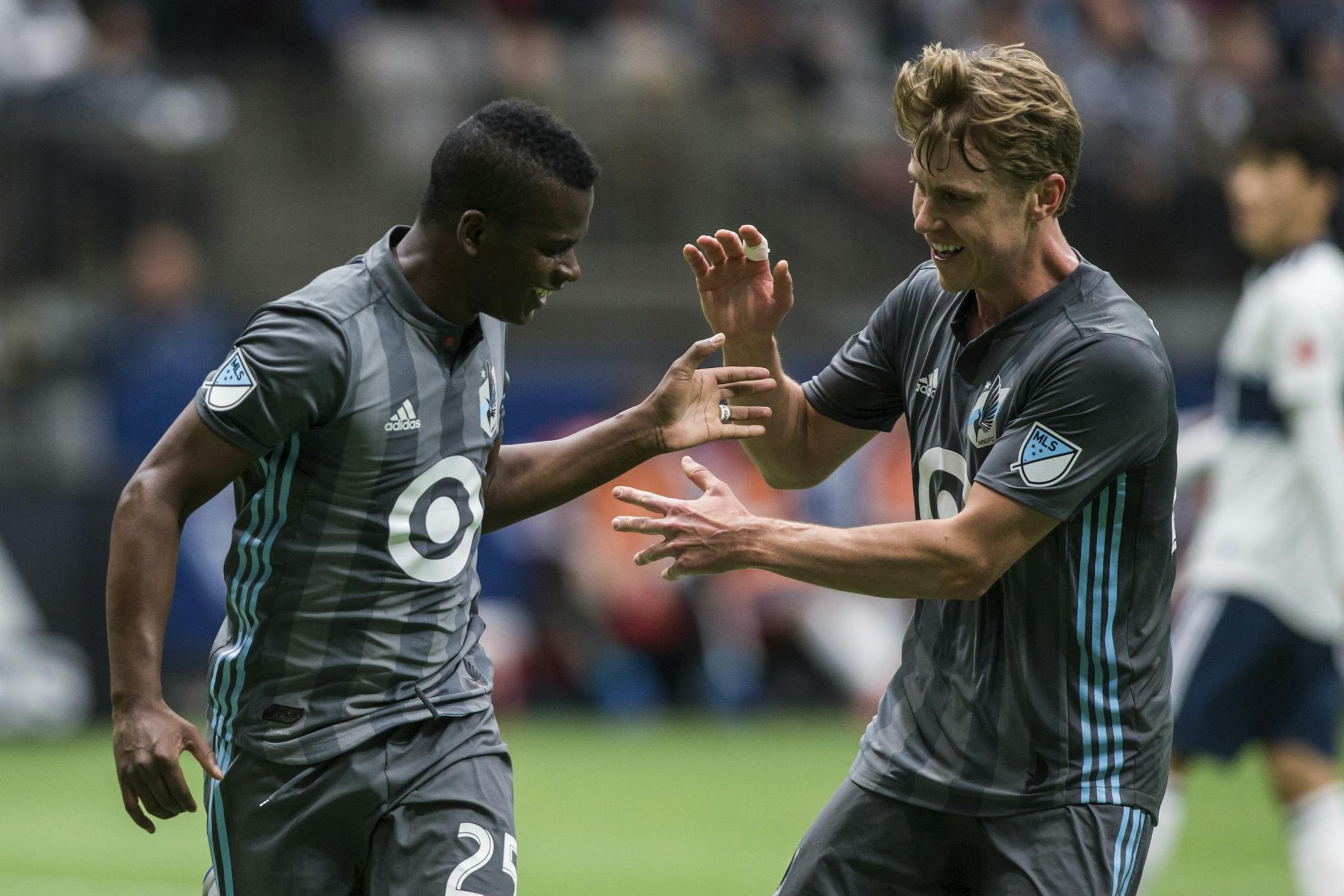 Minnesota United's Carlos Darwin Quintero (25) celebrates his goal with Rasmus Schuller during the first half of an MLS soccer match against the Vancouver Whitecaps on Saturday, March 2, 2019, in Vancouver, British Columbia.
