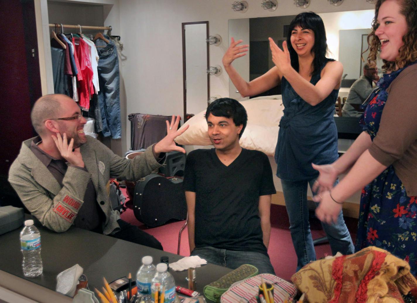 New York actor Debargo Sanyal seemed to be getting direction from all sides backstage at the Playwrights' Center in Minneapolis. He was cast in a staged reading of a new play by Aditi Kapil (standing at rear), directed by Jeremy Cohen. At right is stage manager Callie Meiners.