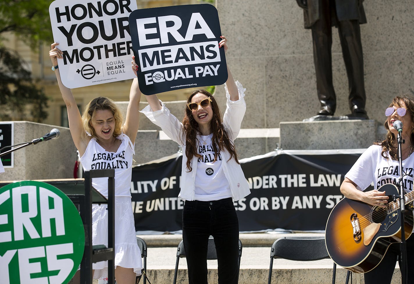 Actress and model Lizzy Jagger, center, the eldest daughter of Mick Jagger and Jerry Hall, joins others at a rally in support of the Equal Rights Amendment on the steps of the Capitol Tuesday, May 8, 2018 in Springfield, Ill. Rally participants urged the Illinois House to pass a joint resolution ratifying the constitutional amendment. (Rich Saal/The State Journal-Register via AP)