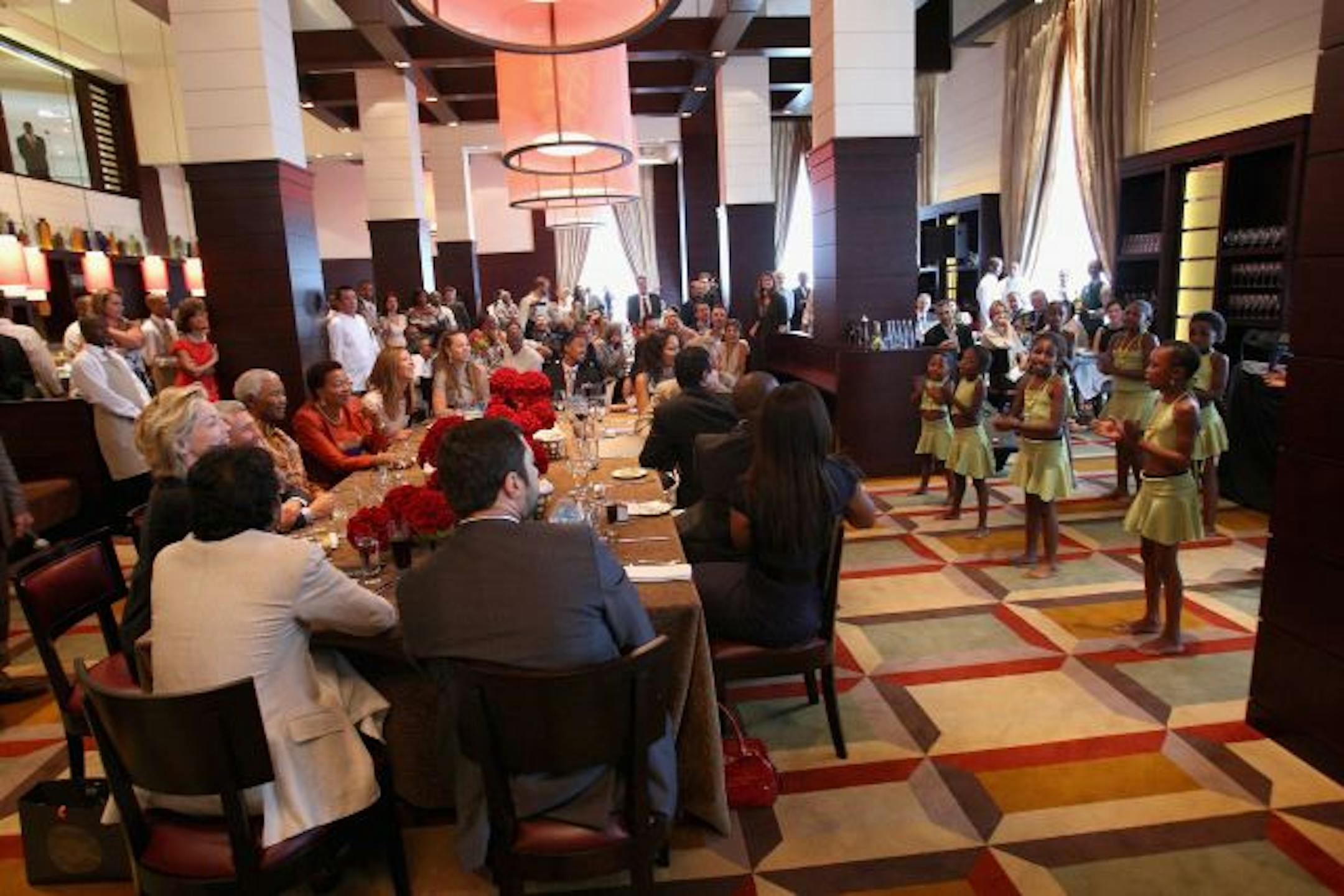 Children perform for Nelson Mandela during a lunch to Benefit the Mandela Children's Foundation as part of the celebrations of the opening of the new One&Only Cape Town resort on April 3, 2009 in Cape Town, South Africa. The One&Only is Sol Kerzner's first hotel in his home country since 1992. The 130 room property is One&Only's first Urban resort and sits in the fashionable Waterfront district. Celebrities from all over the world including Mariah Carey, Clint Eastwood, Matt Damon, Morgan Freema