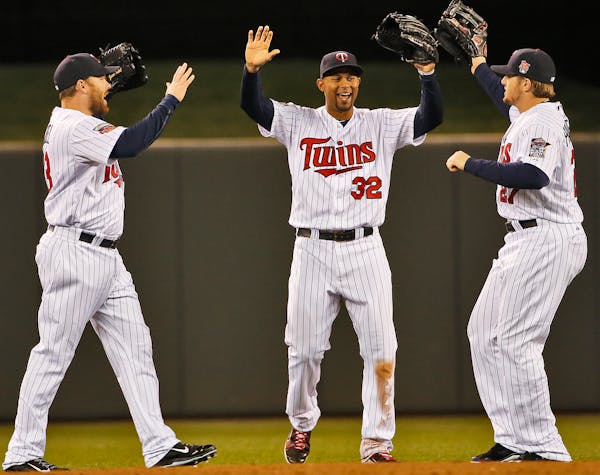 It was a happy Twins outfield as Jason Kubel, Aaron Hicks and Chris Parmelee, l-r, celebrated a Twins win after the 3rd out was recorded in the 9th in