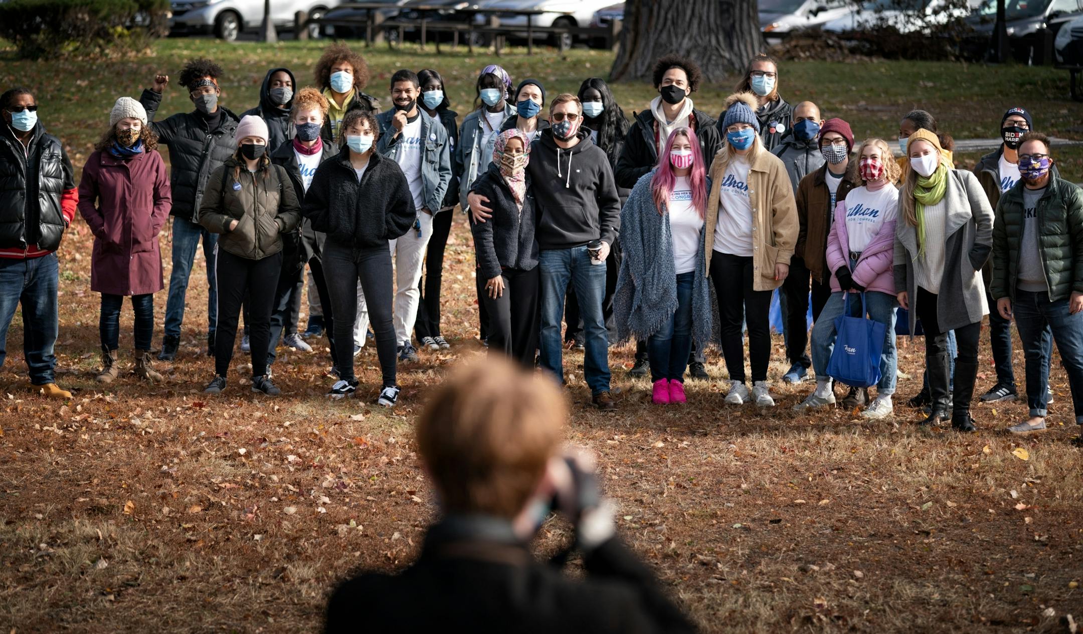 U.S. Rep Ilhan Omar staffers and volunteers posed for a group photo in Powderhorn Park before the split into teams to door knock around the neighborhood. With Omar in the center is her husband Tim Mynett.