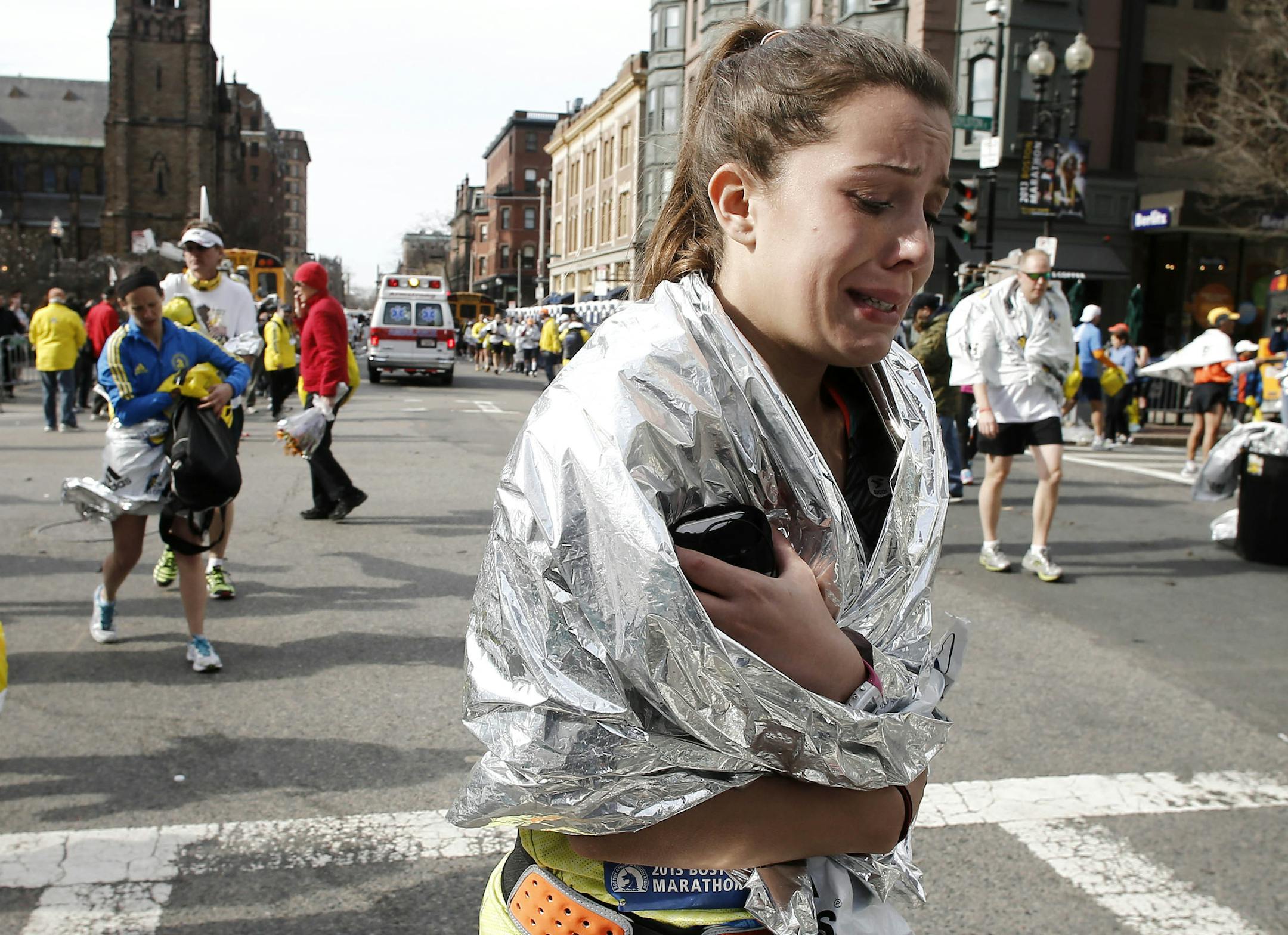 An unidentified Boston Marathon runner leaves the course crying near Copley Square following an explosion in Boston (April 15, 2013).