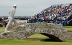 United States' Dustin Johnson crosses Swilcan Bridge on hole 18 during the first round of the British Open Golf Championship at the Old Course, St. An