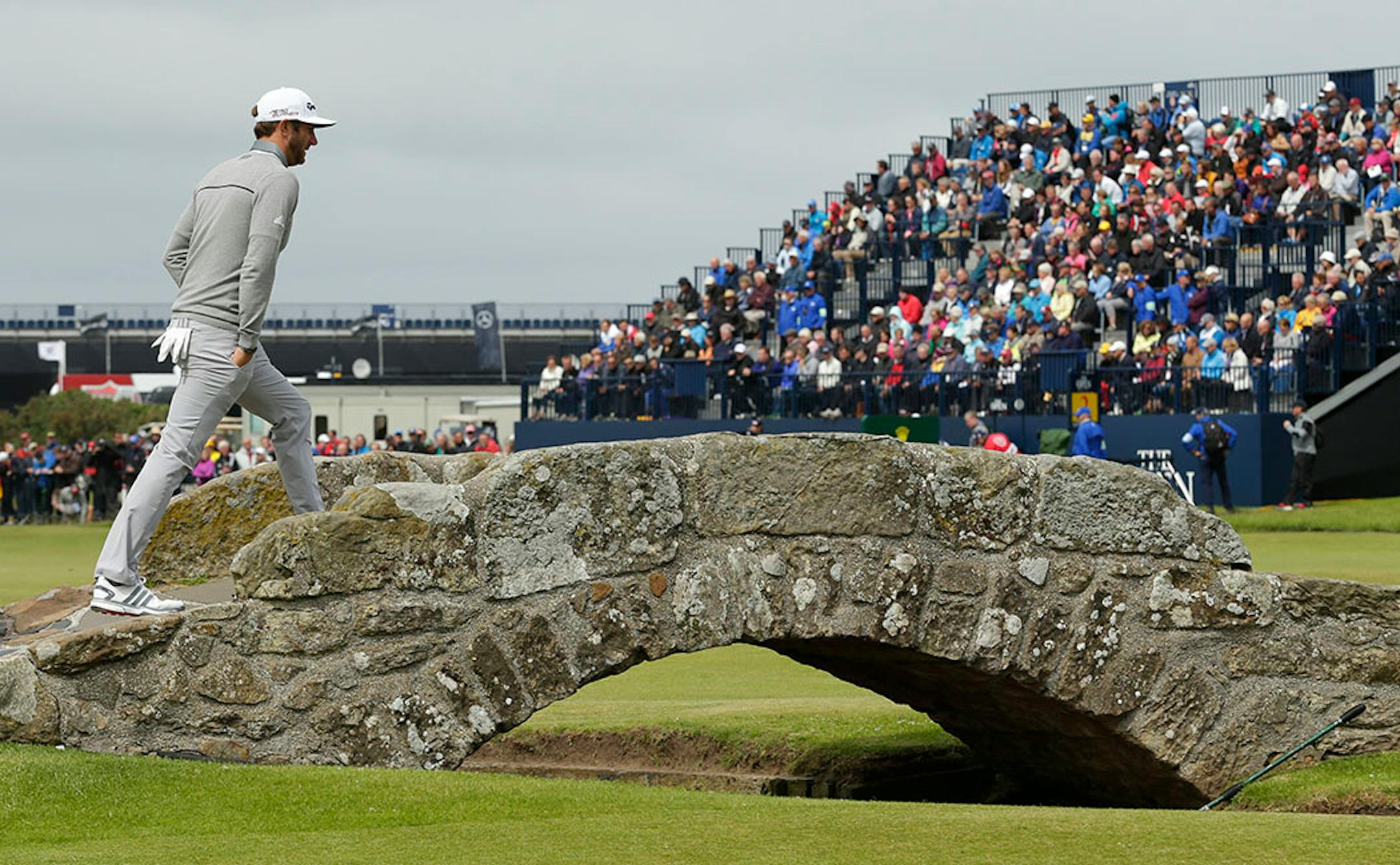 United States' Dustin Johnson crosses Swilcan Bridge on hole 18 during the first round of the British Open Golf Championship at the Old Course, St. Andrews, Scotland, Thursday, July 16, 2015.