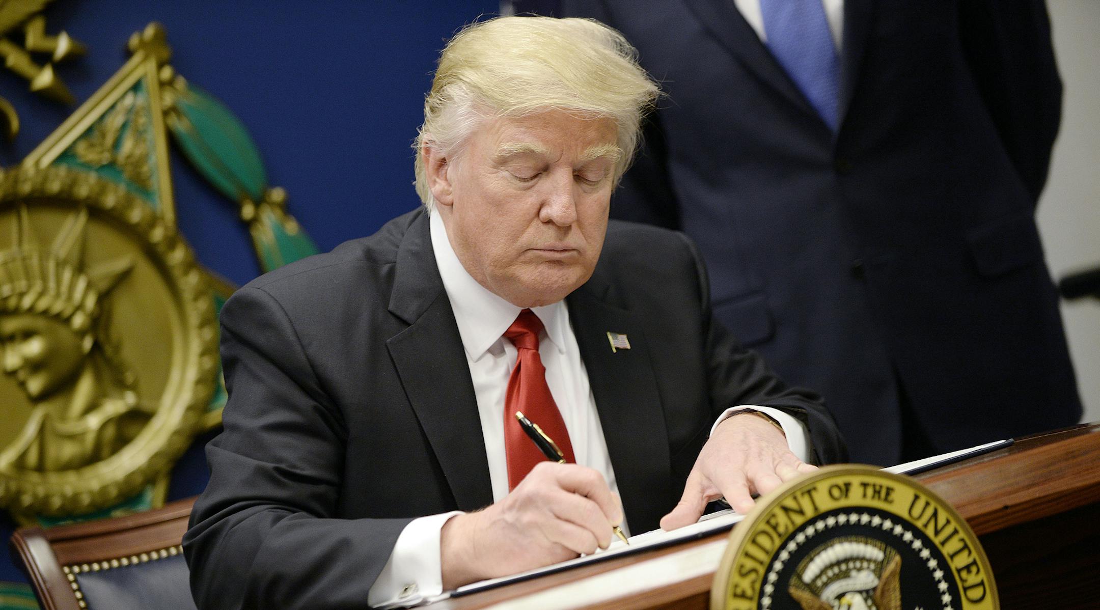 United States President Donald Trump signs Executive Orders in the Hall of Heroes at the Department of Defense in Virginia, January 27, 2017. Credit: Olivier Douliery / Pool via CNP /MediaPunch/IPX ORG XMIT: IPX