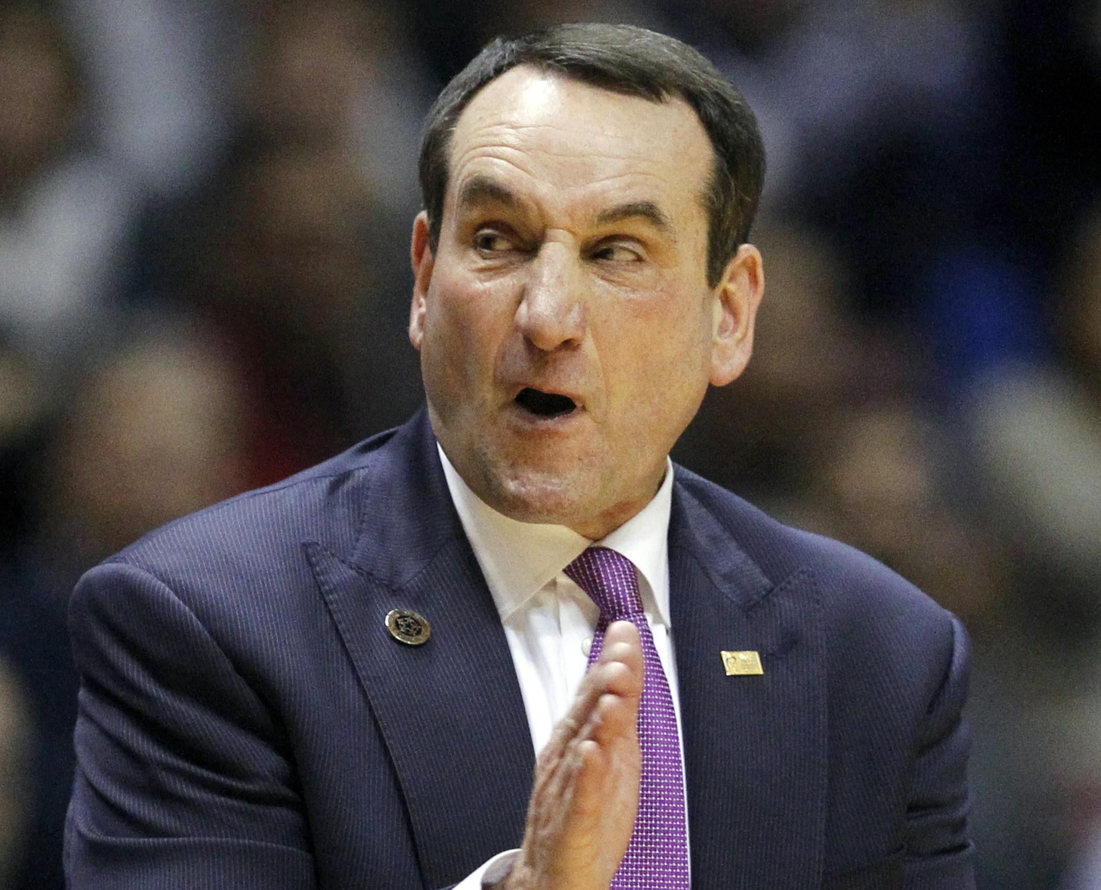 FILE - In this Dec. 18, 2014, file photo, Duke head coach Mike Krzyzewski claps during the second half of an NCAA college basketball game against Connecticut in East Rutherford, N.J. The Duke coach will become the first men's coach in Division I with 1,000 wins on Sunday if his fifth-ranked Blue Devils beat St. John's. (AP Photo/Julio Cortez, File)