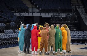 The Andover boys basketball team arrives on the court dressed in characters for a pep talk before they take on Park Center in the Class 4A basketball 