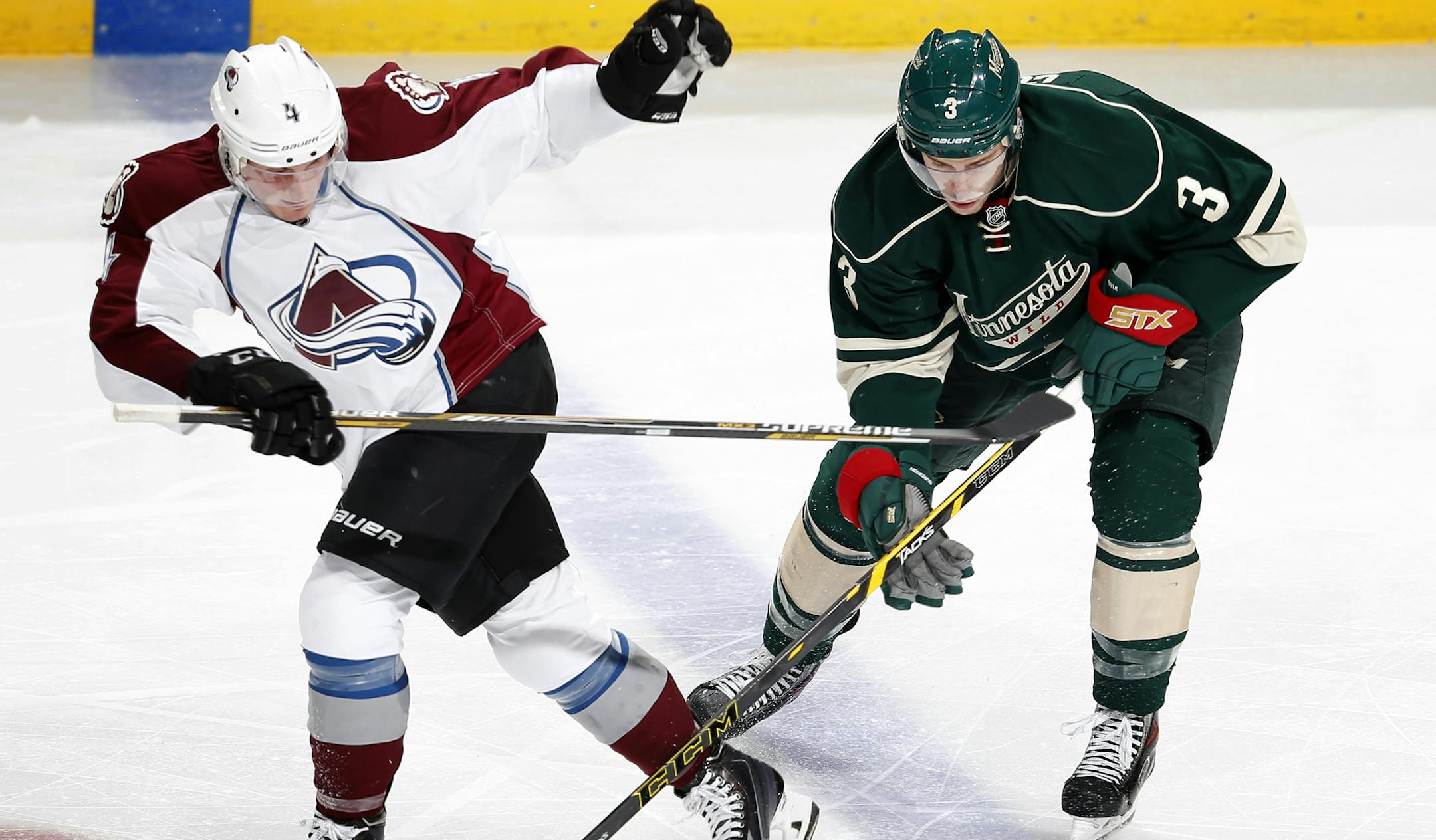 Tyson Barrie (4) and Charlie Coyle (3) fought for the puck in the second period. ] CARLOS GONZALEZ cgonzalez@startribune.com - October 9, 2014 , St. Paul, Minn., Xcel Energy Center, NHL, Minnesota Wild vs. Colorado Avalanche Season opener