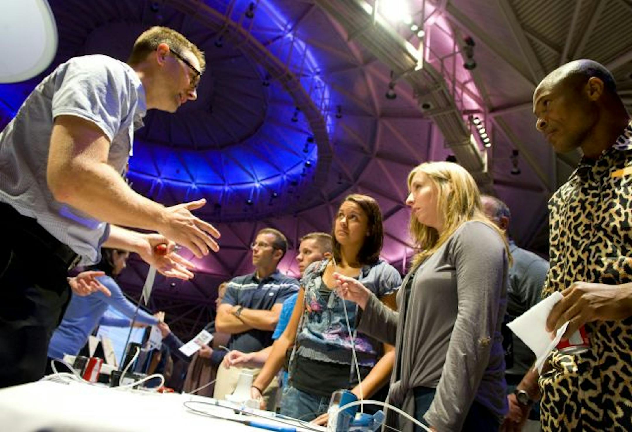 Boston Scientific employee Greg Benz showed angioplasty devices to other employees during Thursday's gathering.