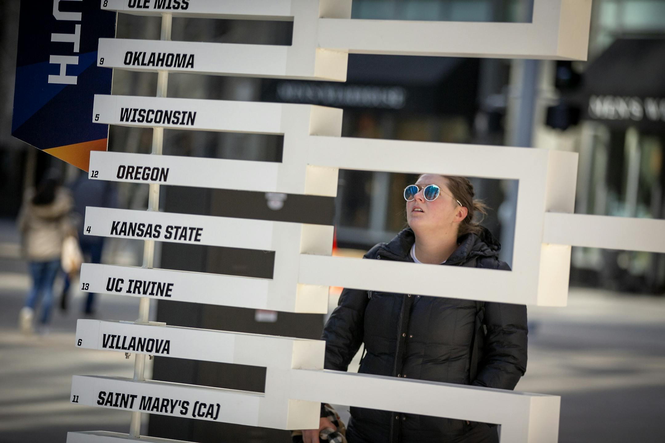 Marli Komarek, cq, searched for her favorite team, Wisconsin, on a 3D sculpture of the Final Four bracket on the Nicollet Mall just outside the IDS tower, Monday, March 18, 2019 in Minneapolis, MN.
