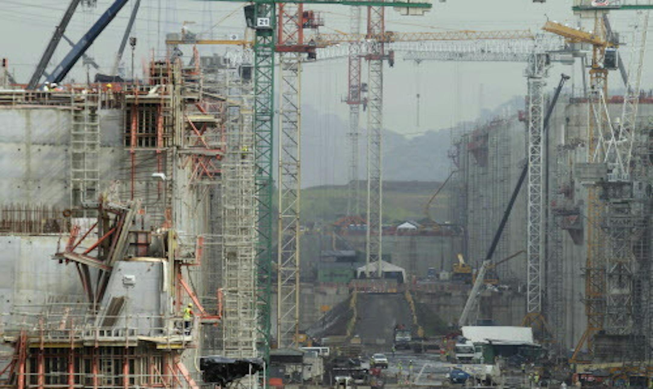 Cranes tower over the construction site of Panama Canal's Pacific expansion project in Cococli, on the outskirts of Panama City, Friday, Aug. 8, 2014. August 15, marks the 100th anniversary of the Panama Canal construction, as it undergoes the biggest expansion project since it opened in 1914, which will allow larger Post-Panamax ships to cross the canal. (AP Photo/Arnulfo Franco)
