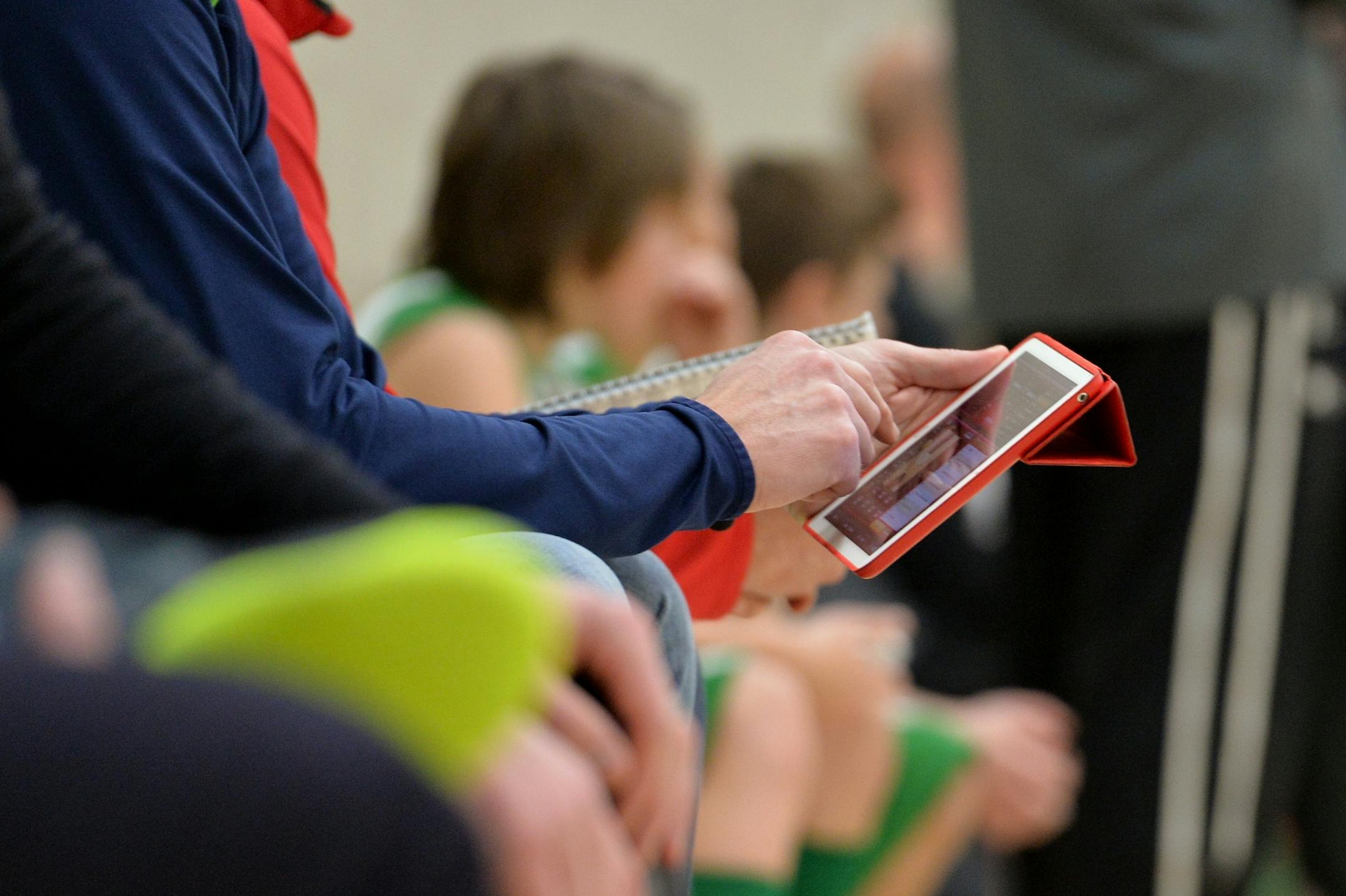 Edina's 4A traveling boys' basketball team parents, Mike Munson records player statistics into an iPad using the app, iScore.