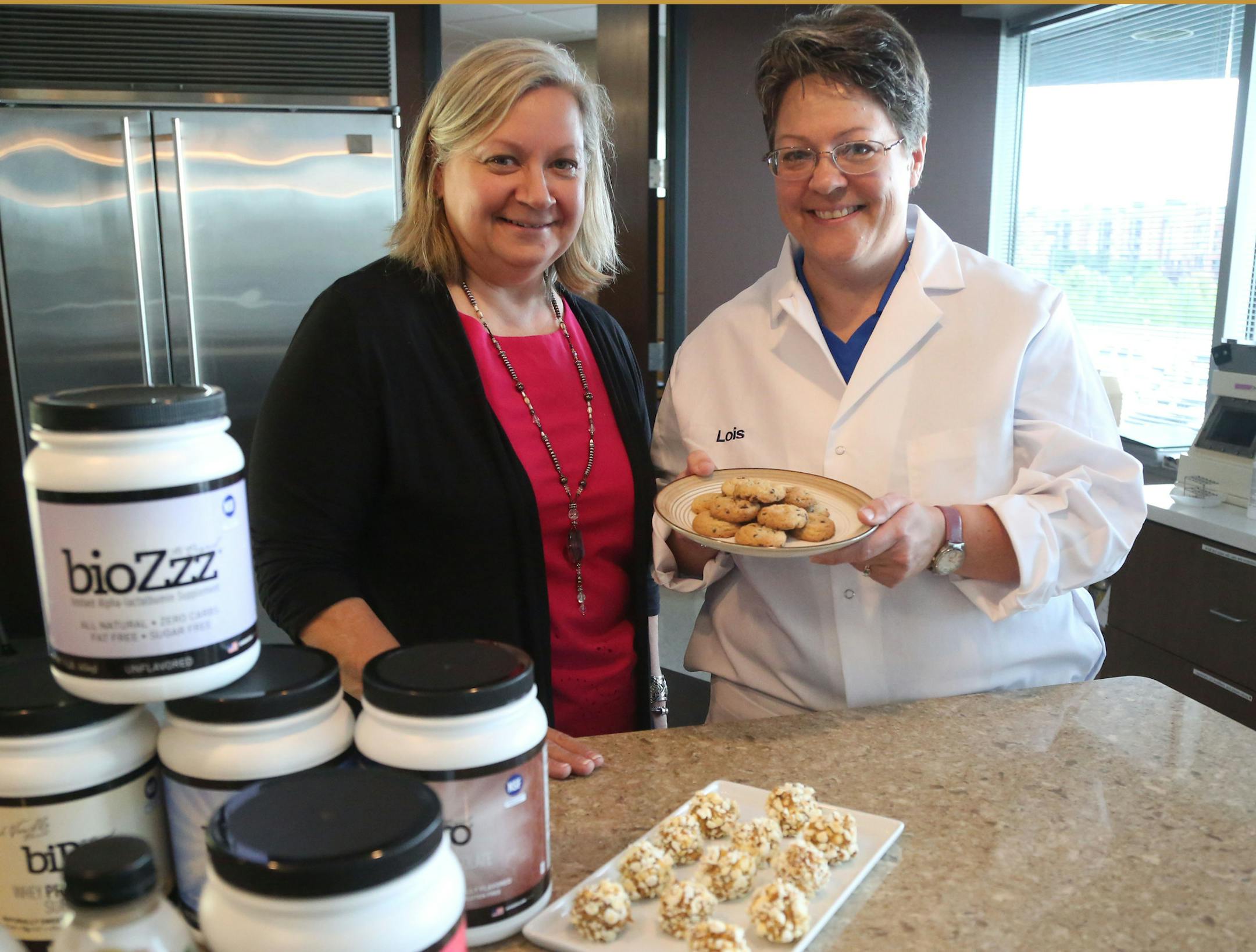 Polly Olson, vice president of business development, sales and marketing at BiPro, left, and Lois Baker, BiPro senior scientist, in the firm’s research lab.