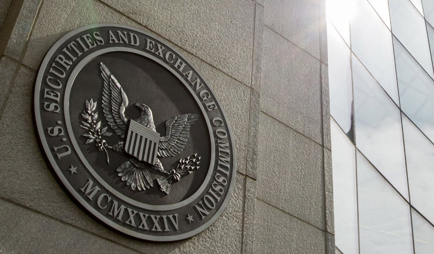 FILE - This June 19, 2015 file photo shows the seal of the U.S. Securities and Exchange Commission at SEC headquarters, in Washington. The Securities and Exchange Commission on Wednesday, Aug. 5, 2015 voted to order most public companies to disclose the ratio between their chief executives' annual compensation and median, or midpoint, employee pay. The new rule will take effect starting in 2017. (AP Photo/Andrew Harnik, File)