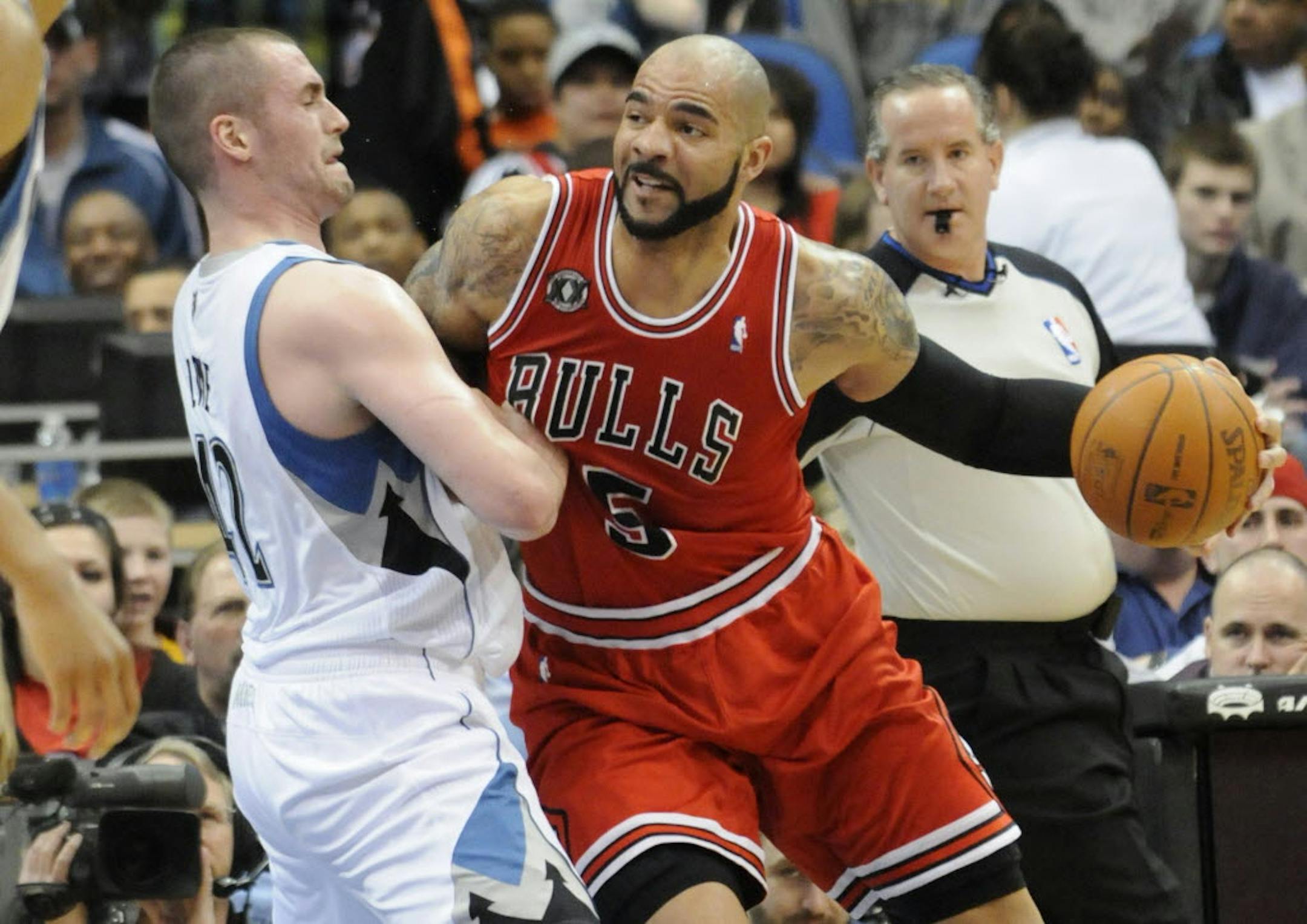 Kevin Love (left, guarding the Bulls' Carlos Boozer) talked Monday all about the Wolves' needs as well as his own, Kurt Rambis and Ricky Rubio.