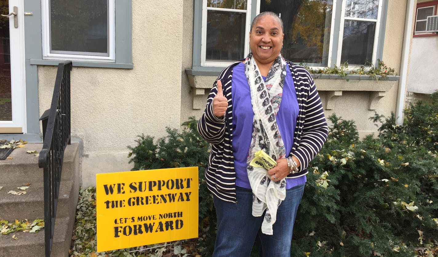 Susan Jones, with the &#xec;We Support the Greenway&#xee; sign says she likes it that children can play in the street without cars driving through the neighborhood. &#xec;I love it. I love how quiet it is.&#xee;
Photos by Randy Furst