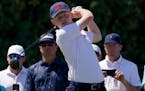 Angus Flanagan, of the Great Britain and Ireland team, watches his tee shot on the third hole in the singles matches during the Walker Cup golf tourna