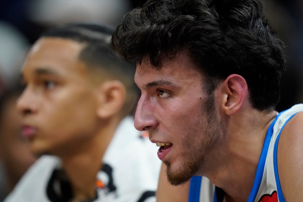 Oklahoma City Thunder forward Chet Holmgren, right, looked on from the bench in the first half during an NBA Summer League basketball game against the