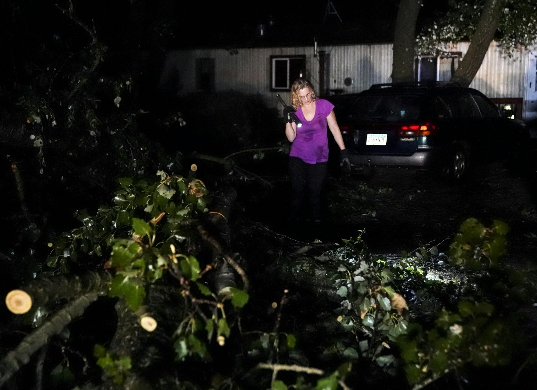 Tonda Nadeau, of Northfield, surveyed damage near her home after a powerful storm tore through the area Thursday night.