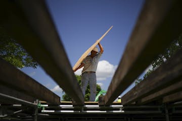 Workers built a walkway at the main entrance to TPC Twin Cities golf course in Blaine on June 6. Thousands pour will into the Anoka County suburb come