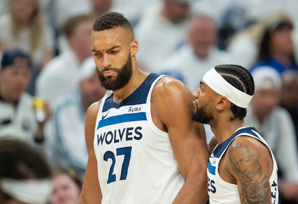 Timberwolves center Rudy Gobert (27) is pulled away from an argument with an official by teammate Nickeil Alexander-Walker on Friday night at Target C