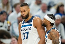Timberwolves center Rudy Gobert (27) is pulled away from an argument with an official by teammate Nickeil Alexander-Walker on Friday night at Target C