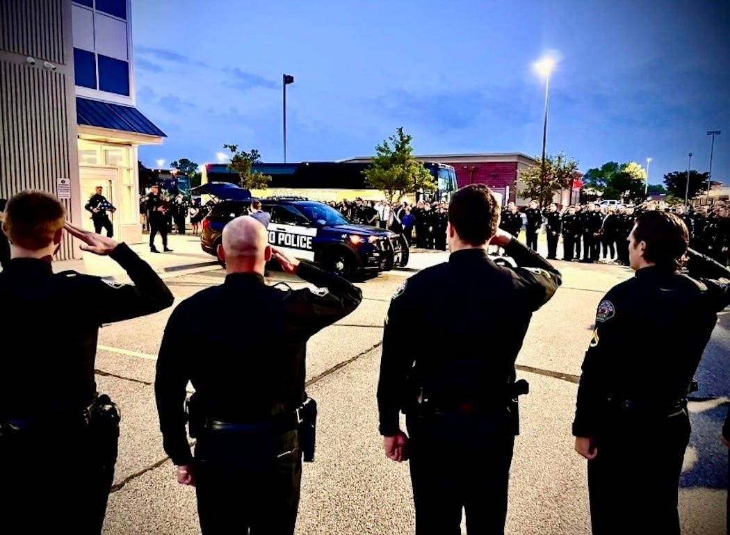 The police procession of 10 squad cars and three buses carrying department employees left Fargo early Saturday for Pequot Lakes. 